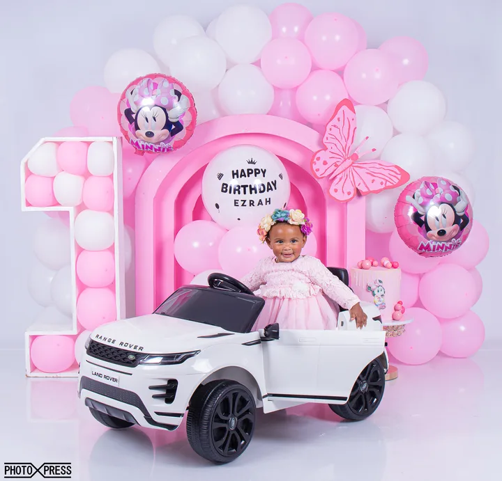 First birthday photoshoot at a toy piano, pink Minnie Mouse theme