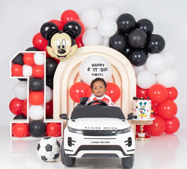 Football and Mickey Mouse themed birthday balloon arch