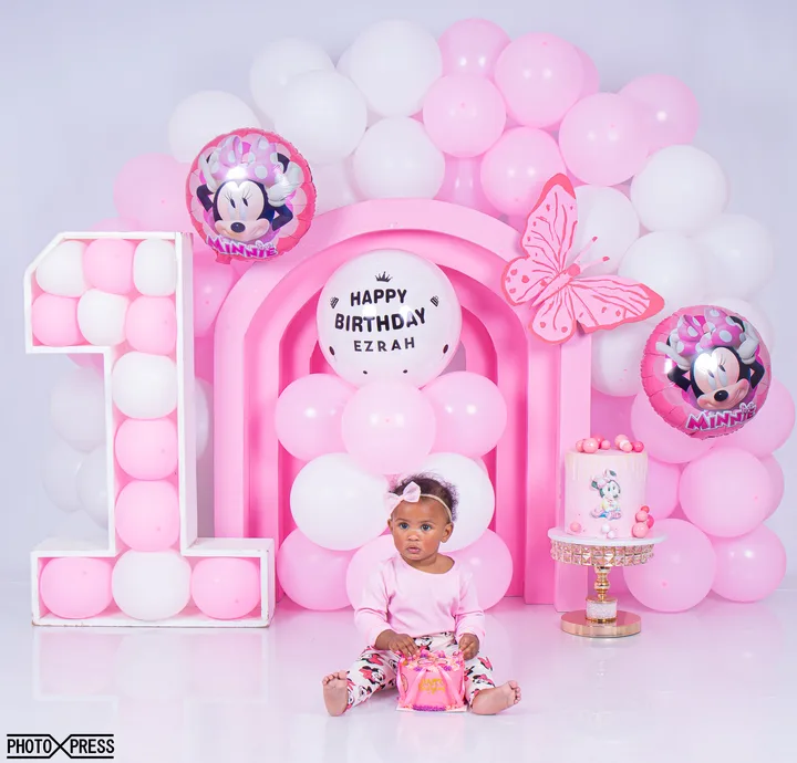 Pink Minnie Mouse themed birthday balloon arch
